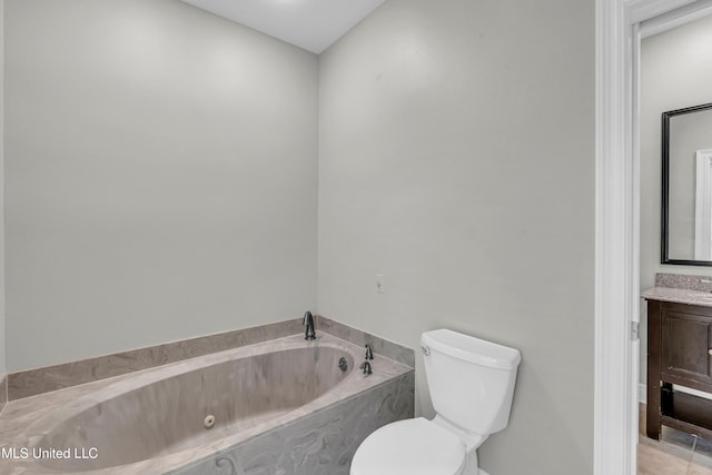 bathroom featuring vanity, toilet, and a washtub