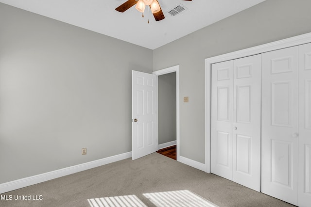 unfurnished bedroom with carpet flooring, a closet, and ceiling fan