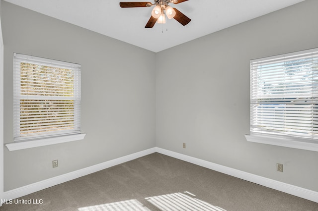 carpeted empty room featuring ceiling fan