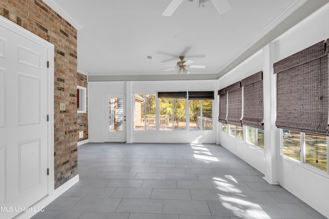 unfurnished sunroom with ceiling fan