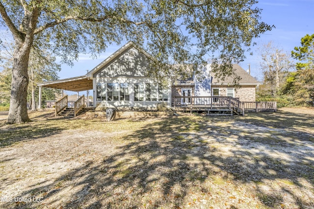 rear view of property with a wooden deck