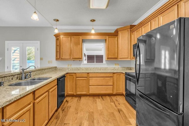 kitchen with black appliances, light hardwood / wood-style floors, sink, decorative light fixtures, and ornamental molding