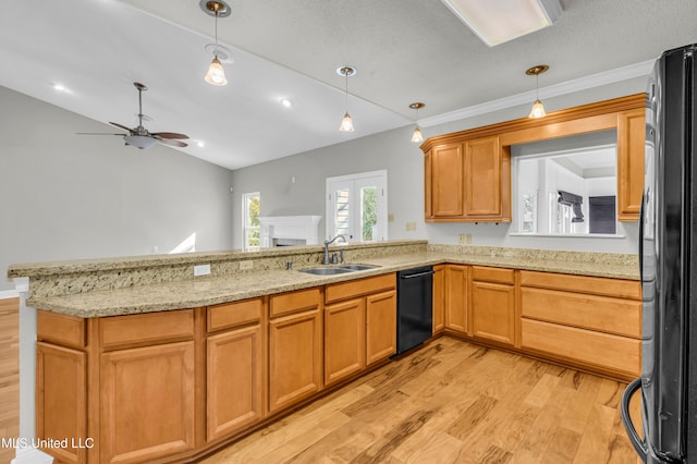 kitchen with vaulted ceiling, black appliances, sink, kitchen peninsula, and light wood-type flooring