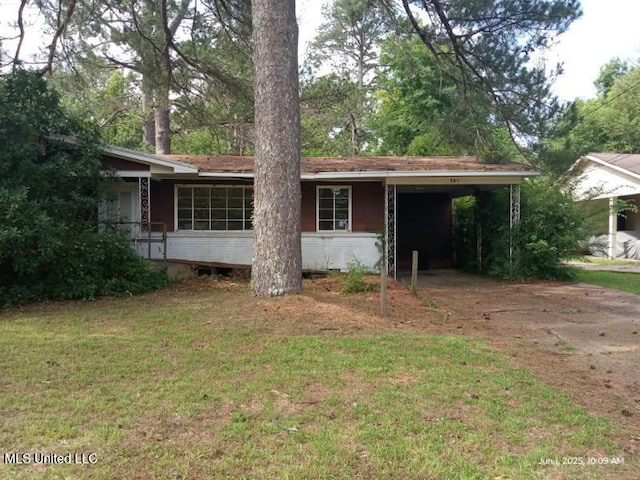751 Dorgan St, Jackson, MS 39204 - view of front facade featuring a carport, concrete driveway, and a front yard
