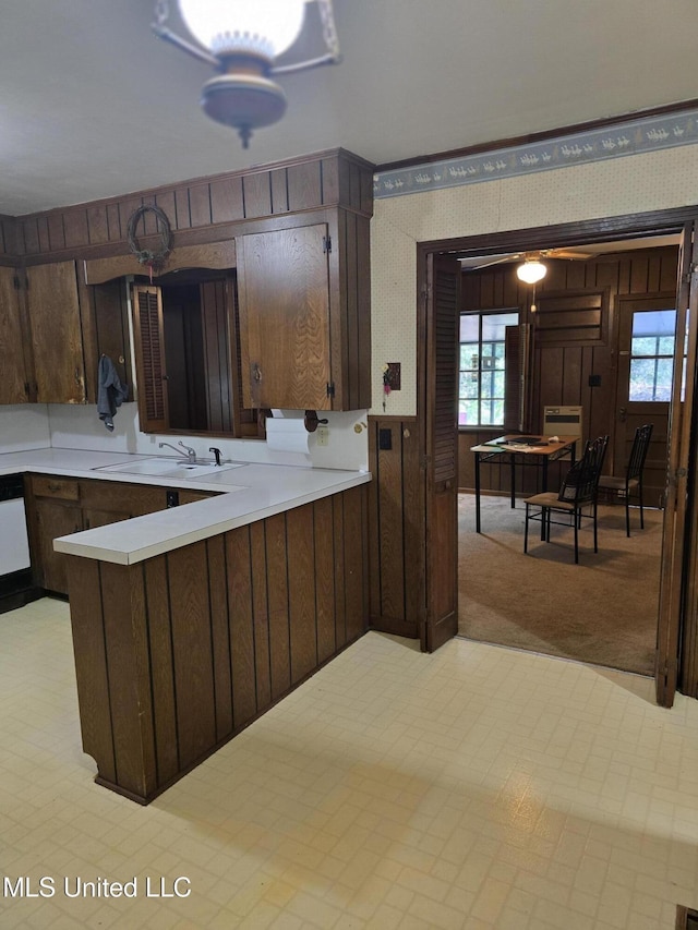 751 Dorgan St, Jackson, MS 39204 - kitchen with a sink, light countertops, plenty of natural light, a peninsula, and wooden walls