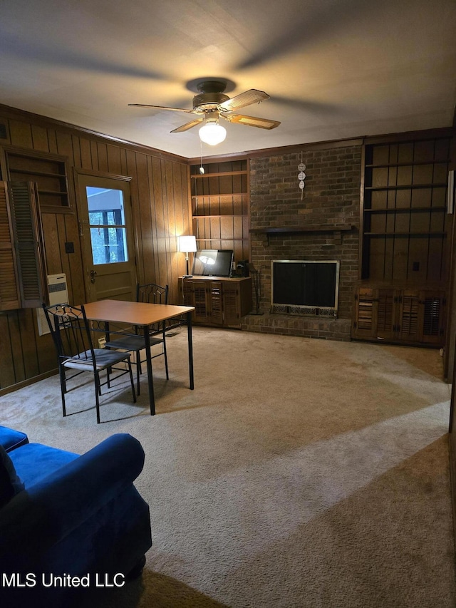 751 Dorgan St, Jackson, MS 39204 - living area with wood walls, carpet floors, a ceiling fan, and a brick fireplace