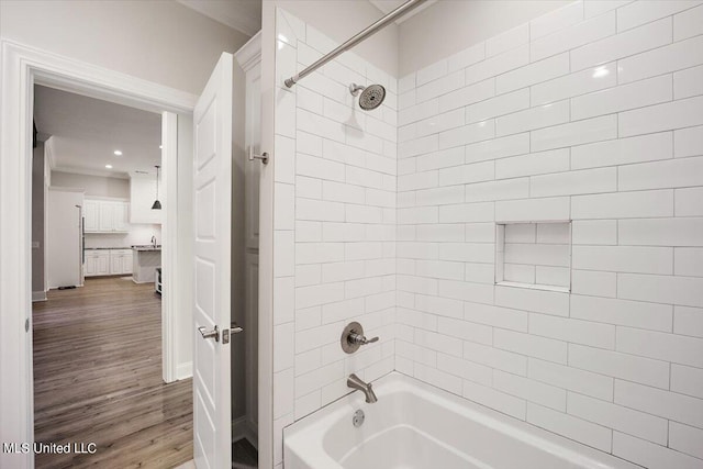 bathroom featuring tiled shower / bath combo and hardwood / wood-style flooring