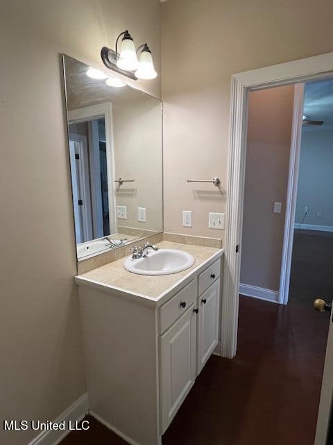 708 Bo Blaze Cv, Brandon, MS 39047 - bathroom featuring vanity, baseboards, and wood finished floors
