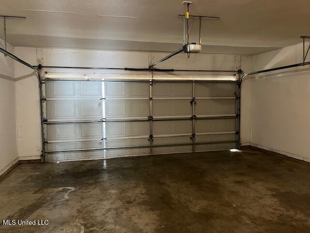 708 Bo Blaze Cv, Brandon, MS 39047 - garage with a garage door opener and baseboards