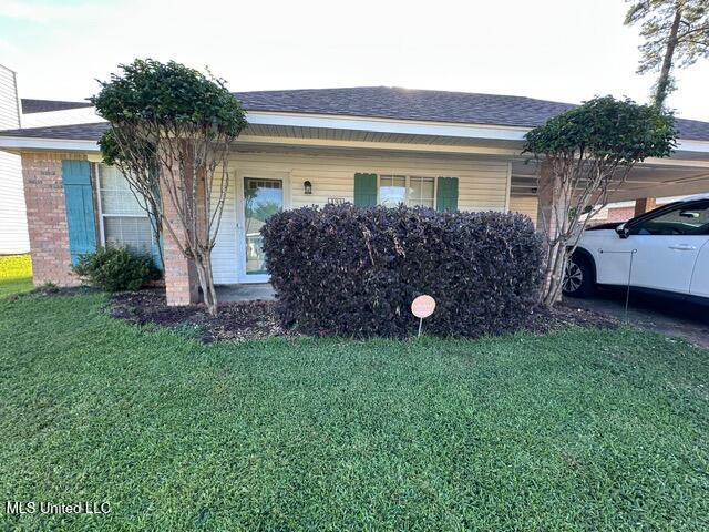 133 Windchase, Brandon, MS 39042 - view of side of property featuring an attached carport, a lawn, a porch, and a shingled roof