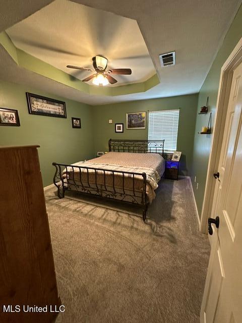 133 Windchase, Brandon, MS 39042 - carpeted bedroom with a tray ceiling and a ceiling fan