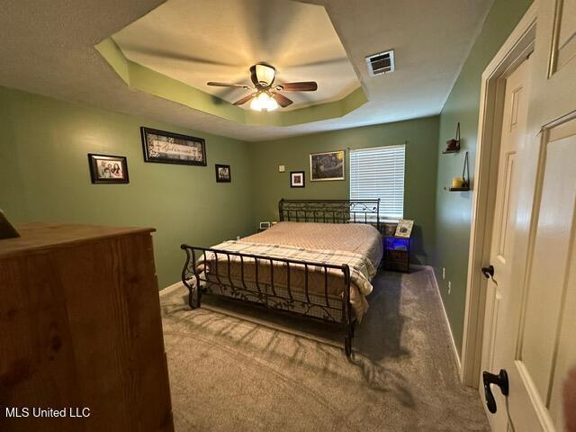 133 Windchase, Brandon, MS 39042 - carpeted bedroom featuring a raised ceiling and a ceiling fan