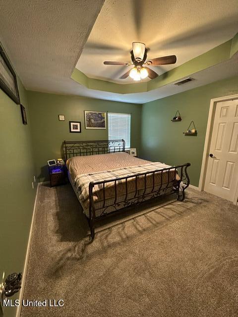 133 Windchase, Brandon, MS 39042 - carpeted bedroom with a textured ceiling, a tray ceiling, and ceiling fan