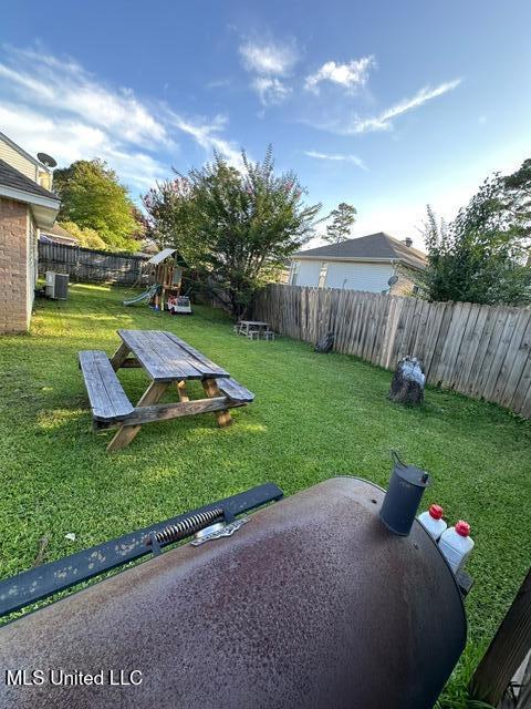 133 Windchase, Brandon, MS 39042 - fenced backyard featuring a playground