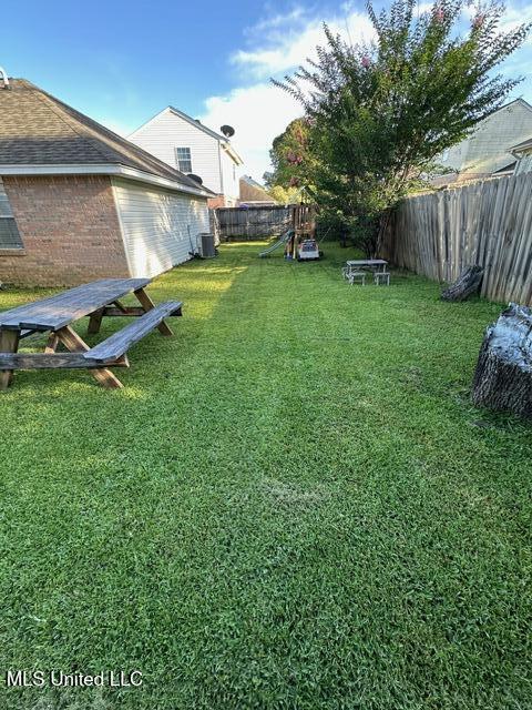 133 Windchase, Brandon, MS 39042 - fenced backyard featuring a playground