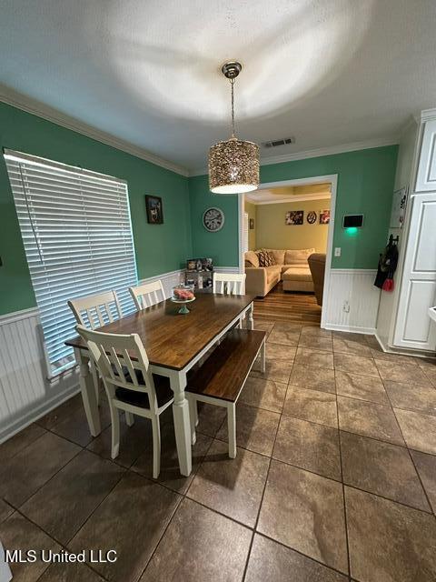 133 Windchase, Brandon, MS 39042 - tiled dining area featuring wainscoting and crown molding