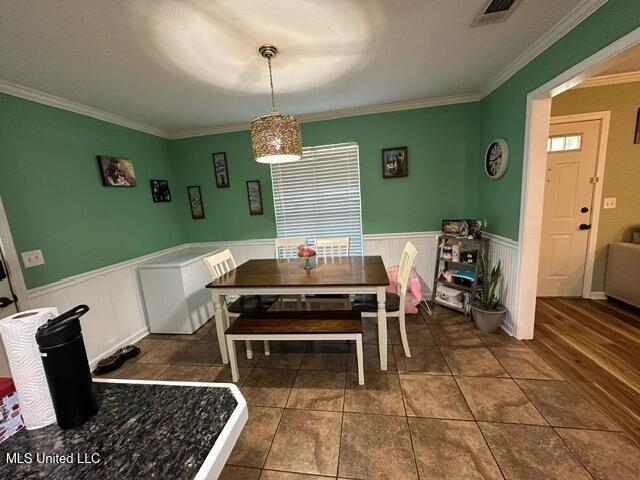 133 Windchase, Brandon, MS 39042 - tiled dining space featuring ornamental molding and a wainscoted wall
