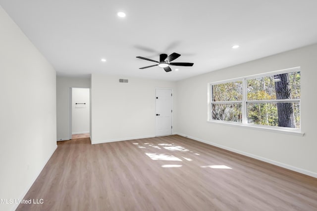 unfurnished room featuring light wood-type flooring, baseboards, visible vents, and recessed lighting