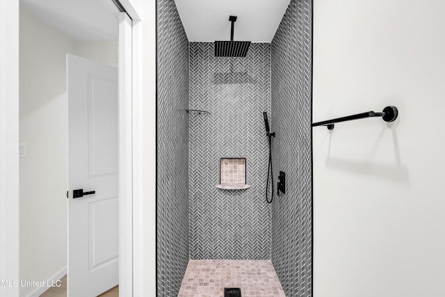 bathroom with a tile shower