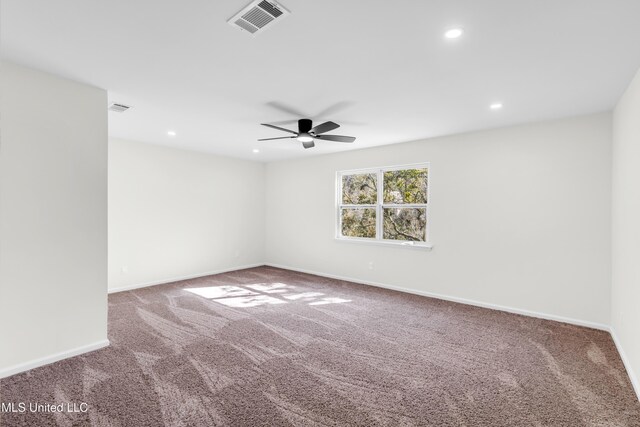 spare room featuring carpet floors, recessed lighting, visible vents, and baseboards