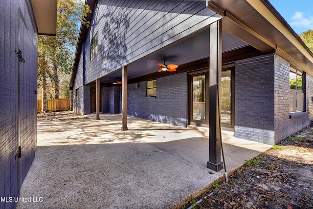 view of patio featuring fence and a ceiling fan