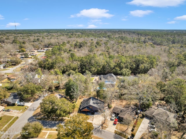 drone / aerial view featuring a wooded view