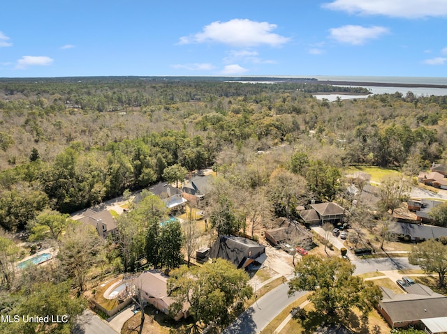 drone / aerial view featuring a water view and a view of trees