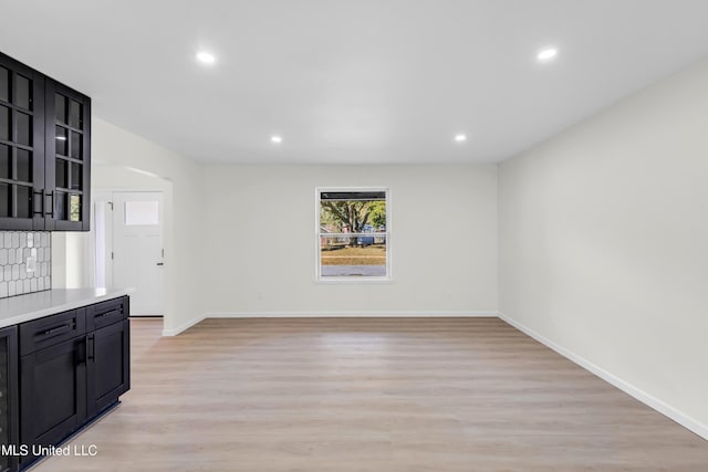 interior space with light wood-type flooring, baseboards, and recessed lighting