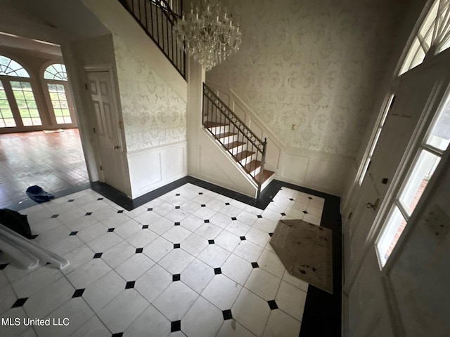 foyer entrance with a notable chandelier