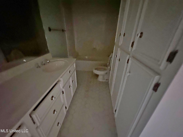 bathroom featuring a bathing tub, vanity, and toilet