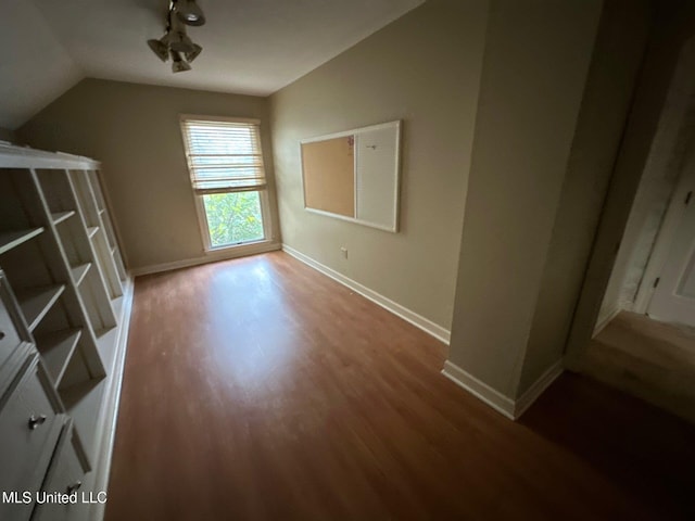 interior space with lofted ceiling and hardwood / wood-style floors