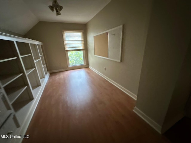 bonus room with hardwood / wood-style floors and vaulted ceiling