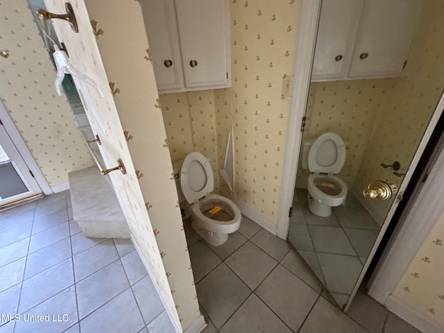 bathroom featuring toilet and tile patterned floors