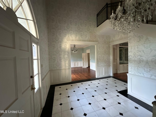 foyer entrance featuring light hardwood / wood-style floors and a chandelier