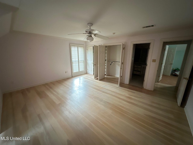 unfurnished bedroom featuring light wood-type flooring and ceiling fan