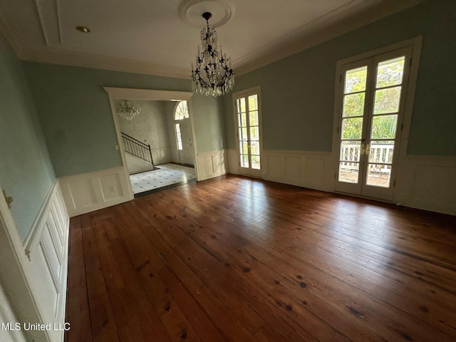 unfurnished dining area with french doors, a wealth of natural light, dark wood-type flooring, and crown molding