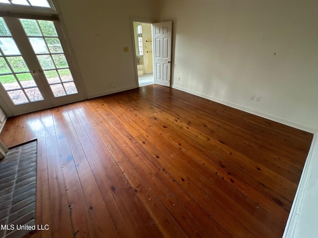 unfurnished room with french doors and dark hardwood / wood-style flooring