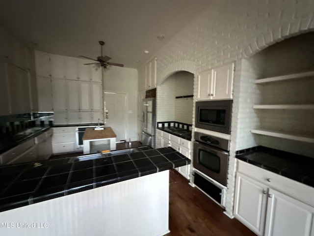 1912 N Petit Bois St, Jackson, MS 39211 - kitchen featuring stainless steel appliances, white cabinetry, tile counters, and a ceiling fan