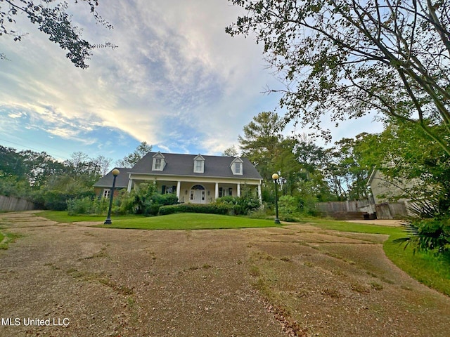 cape cod home with a front yard