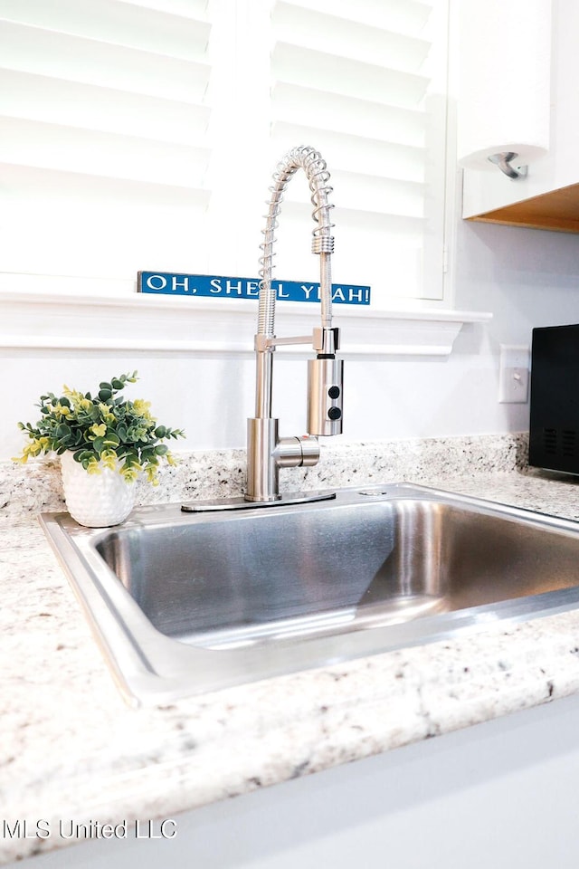 1045 Mckinley St, Waveland, MS 39576 - kitchen view of white cabinets and light stone counters