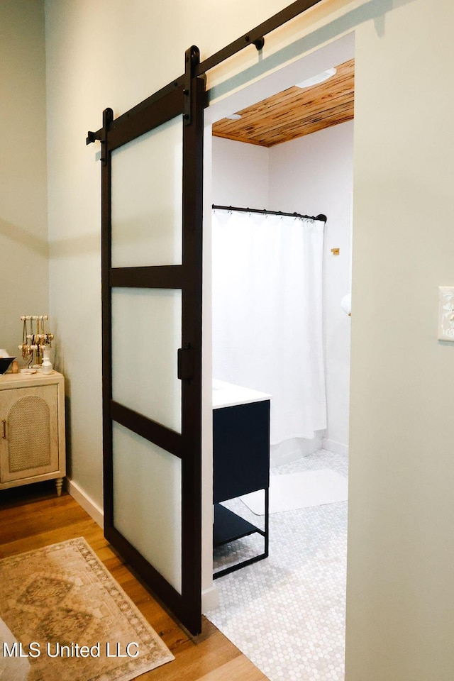 1045 Mckinley St, Waveland, MS 39576 - full bathroom with a shower with shower curtain and wood finished floors