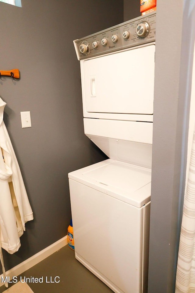 1045 Mckinley St, Waveland, MS 39576 - laundry area featuring stacked washer and clothes dryer and baseboards