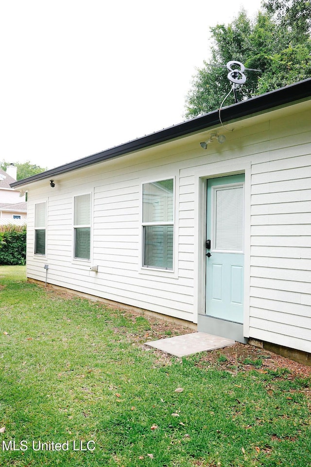 1045 Mckinley St, Waveland, MS 39576 - view of exterior entry featuring a yard