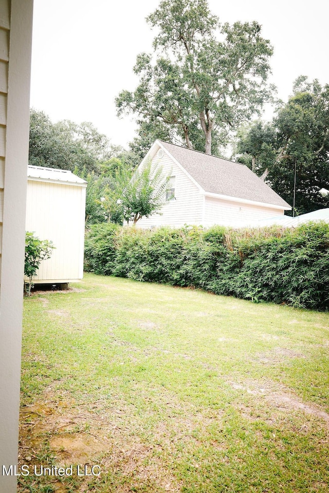 1045 Mckinley St, Waveland, MS 39576 - view of green lawn featuring a storage shed