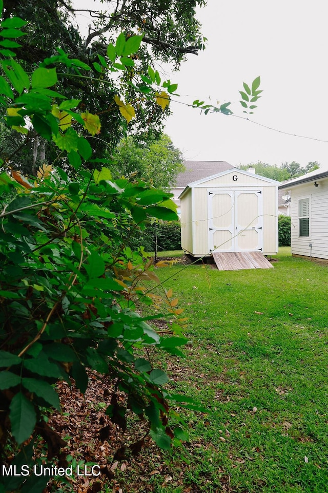 1045 Mckinley St, Waveland, MS 39576 - view of grassy yard featuring a shed