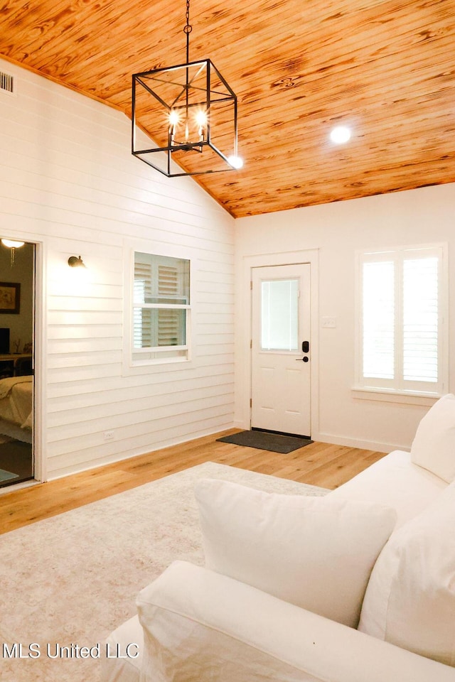 1045 Mckinley St, Waveland, MS 39576 - living room featuring wood ceiling, a chandelier, wood finished floors, and vaulted ceiling