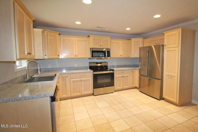 kitchen with a sink, appliances with stainless steel finishes, light brown cabinets, and ornamental molding