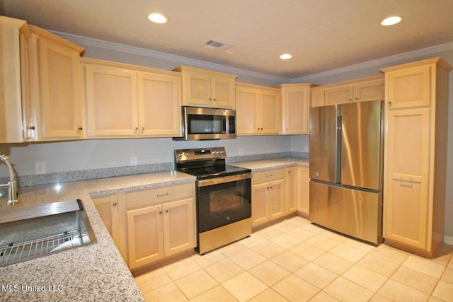 kitchen with visible vents, appliances with stainless steel finishes, a sink, light brown cabinets, and ornamental molding