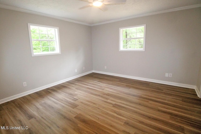 empty room with crown molding, baseboards, ceiling fan, and wood finished floors