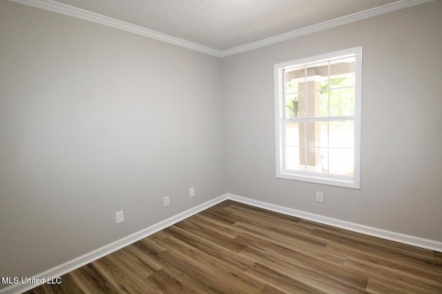 empty room with crown molding, baseboards, and dark wood-style flooring